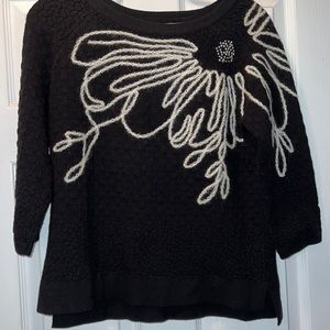 Scoop neck black sweater with design in Ivory.